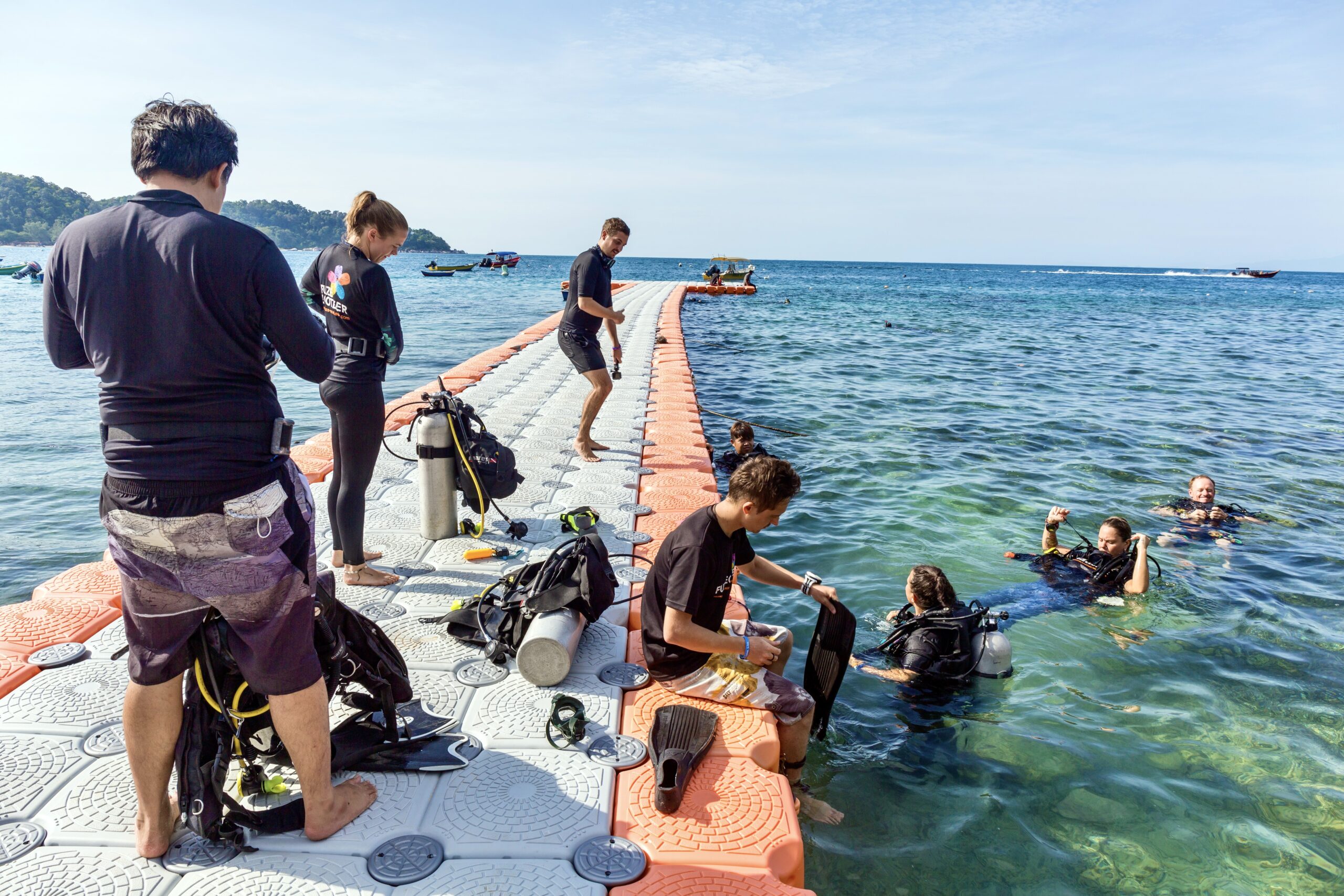 Scuba divers volunteering for a reef cleanup dive in Perhentian